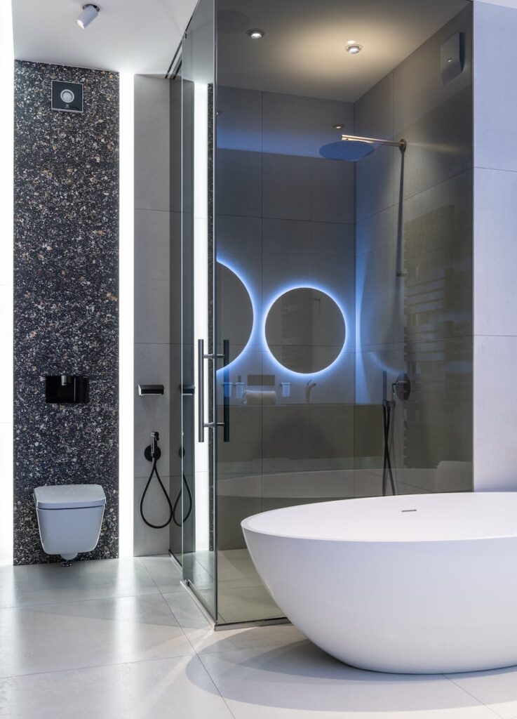 interior of modern spacious bathroom with bright lamps